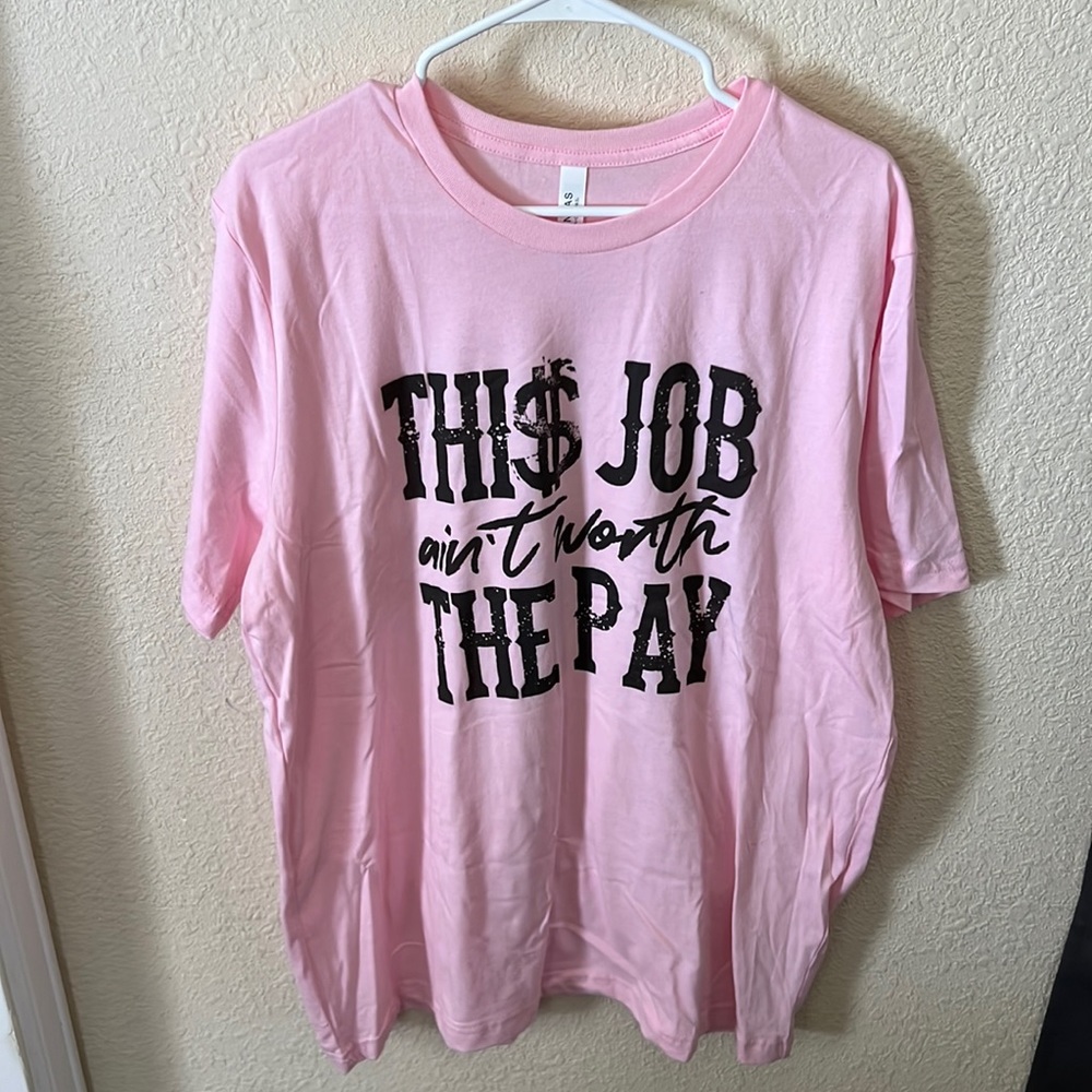 Pink tee with “This job ain’t worth the pay”